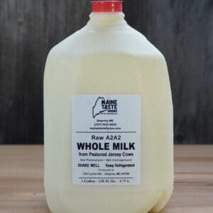 A gallon of milk sitting on top of a table.