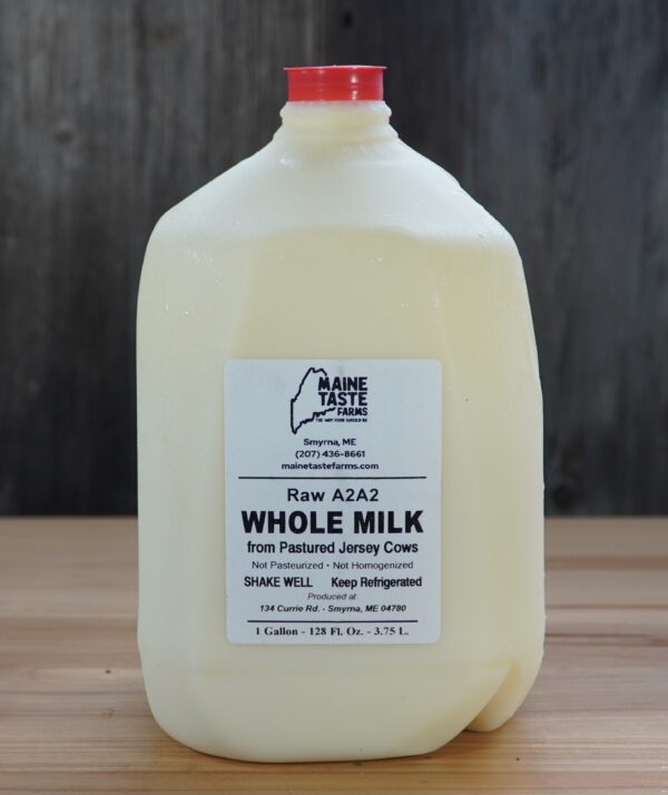A gallon of milk sitting on top of a table.