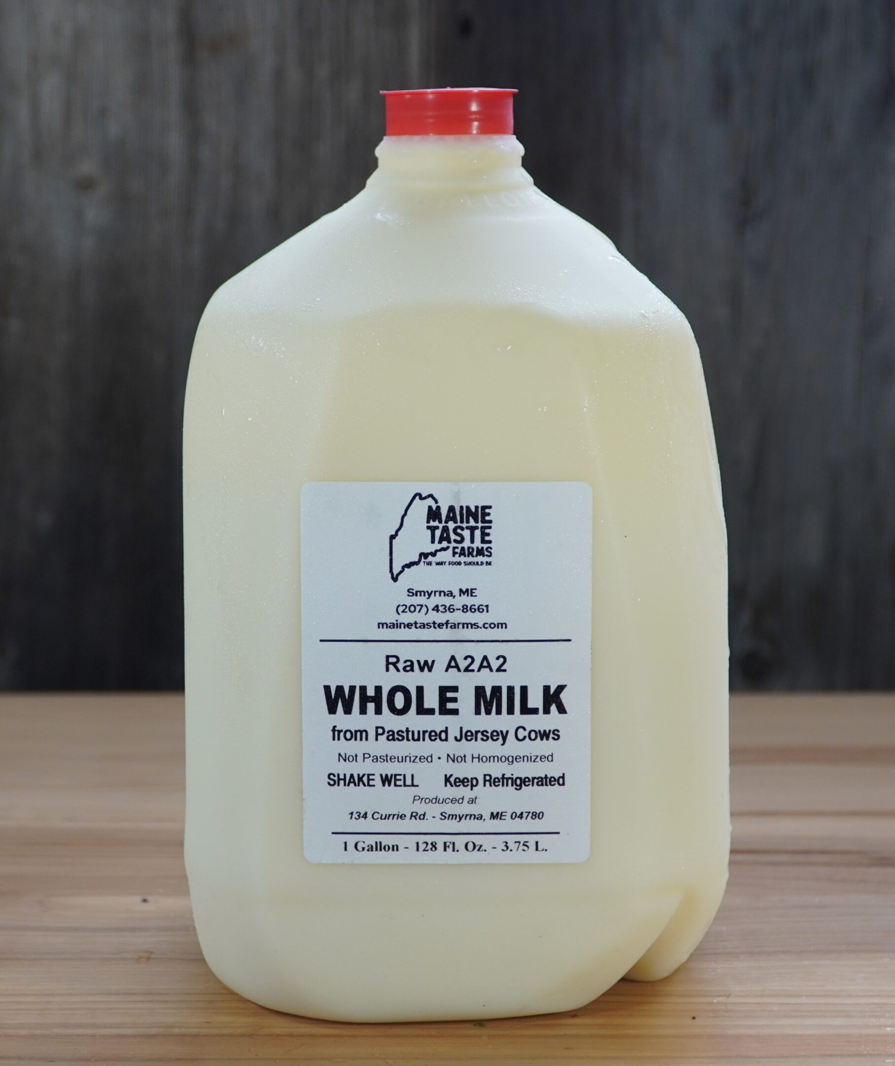 A gallon of milk sitting on top of a table.