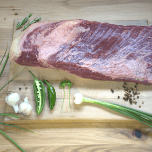 A piece of meat on top of a cutting board.