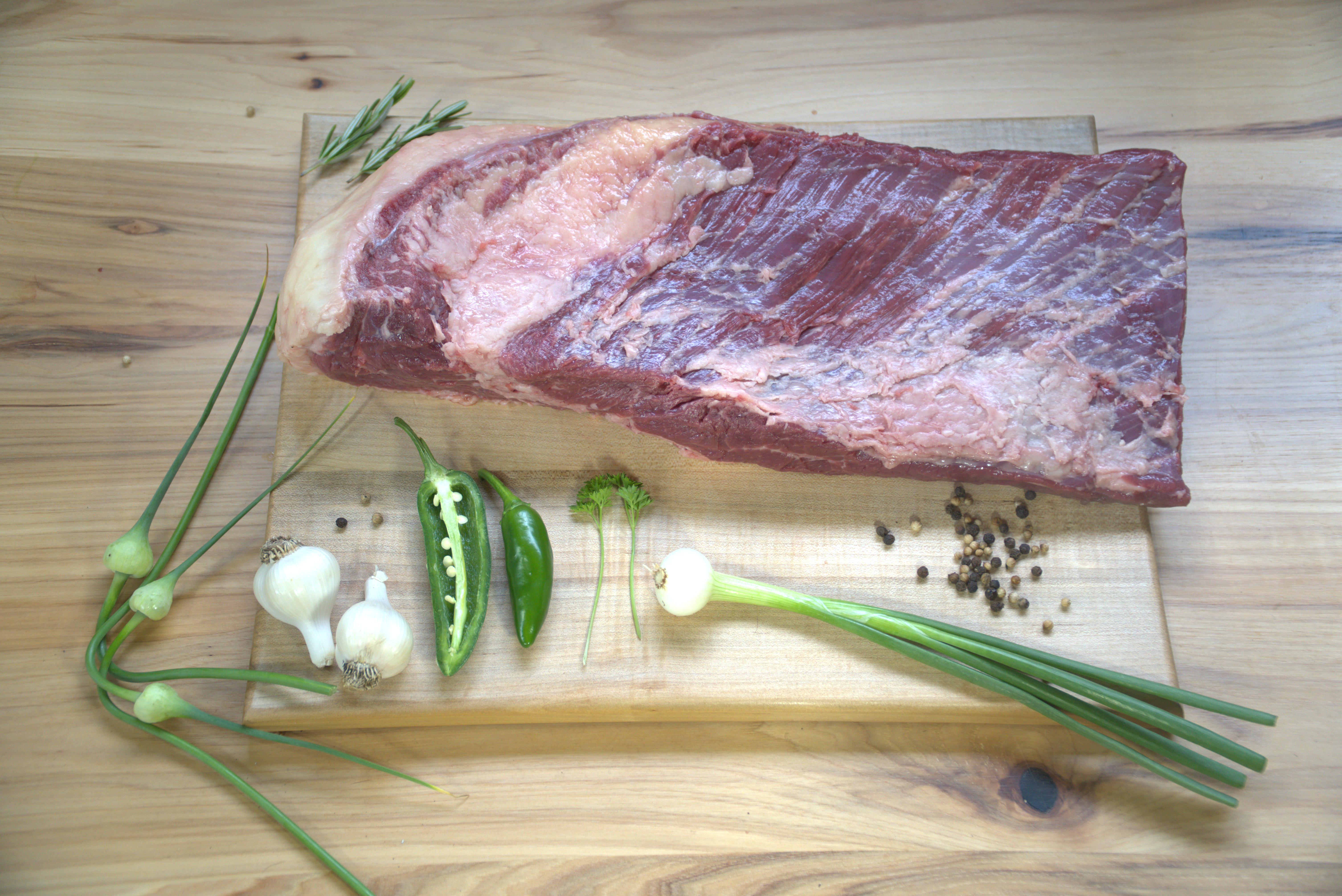 A piece of meat on top of a cutting board.