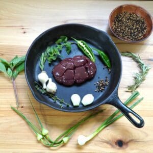 A pan with some meat and vegetables in it