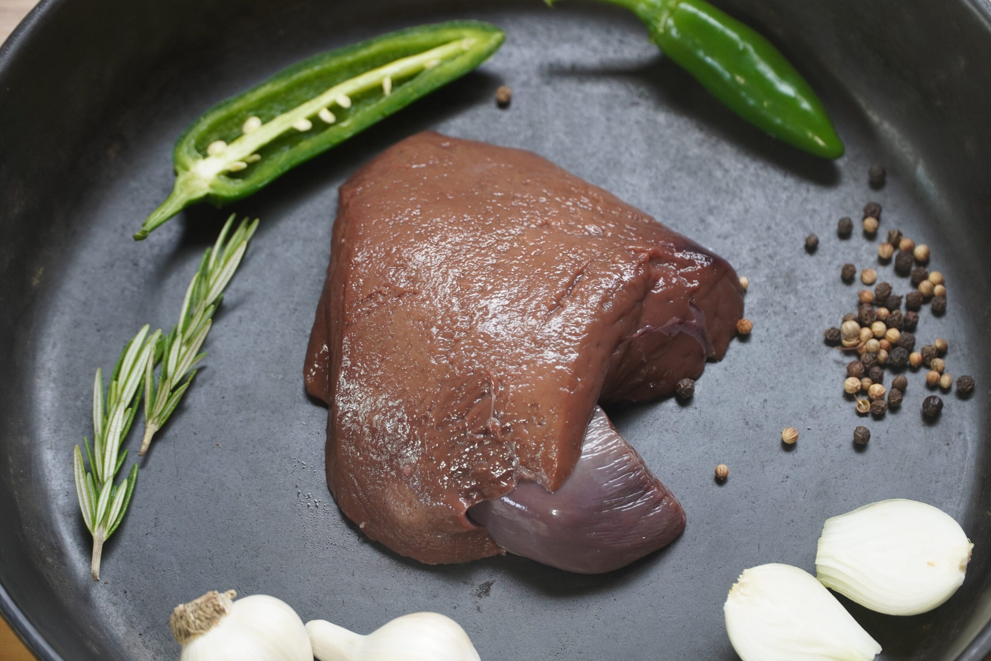 A piece of meat is sitting on the pan.