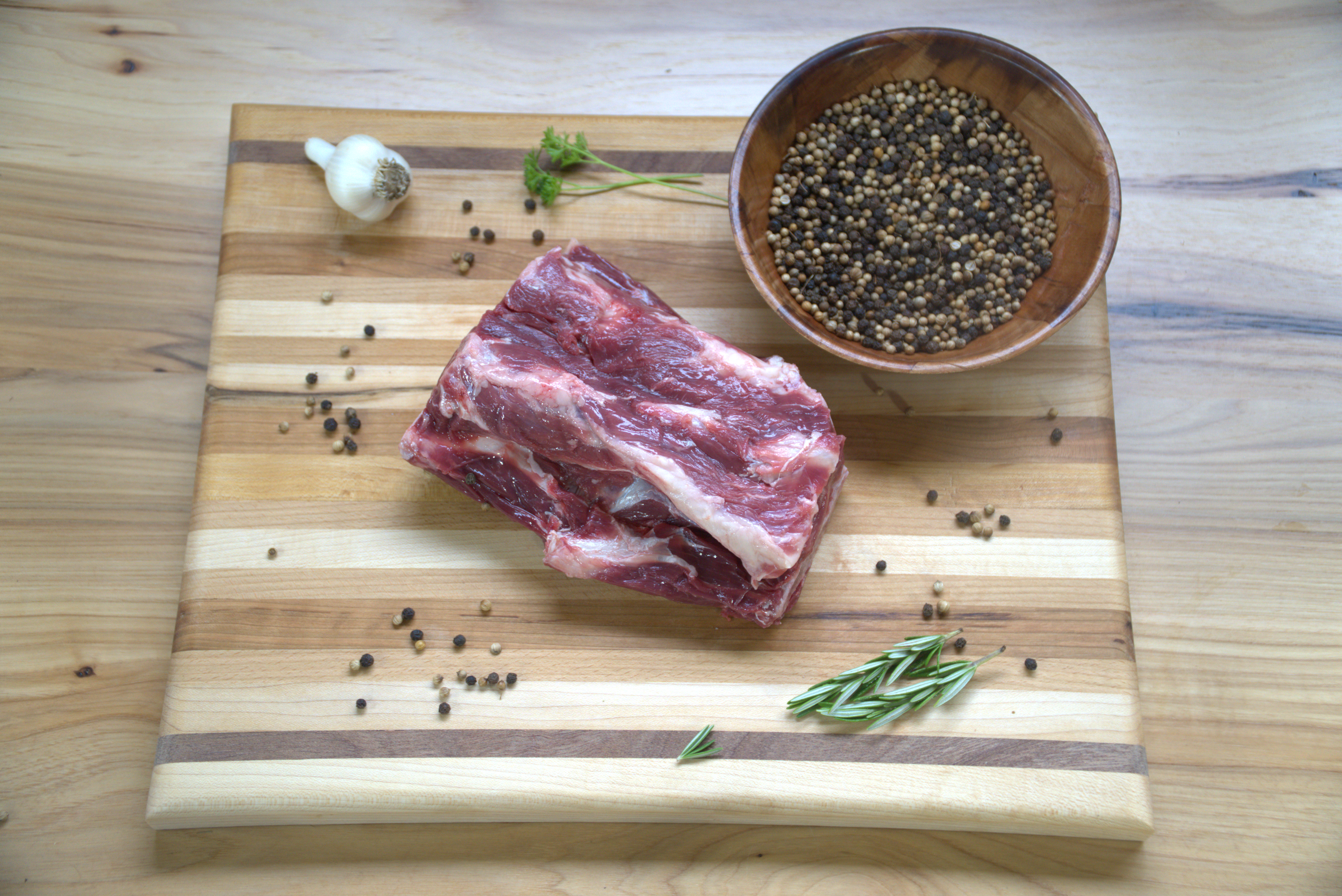 A piece of meat on top of a cutting board.