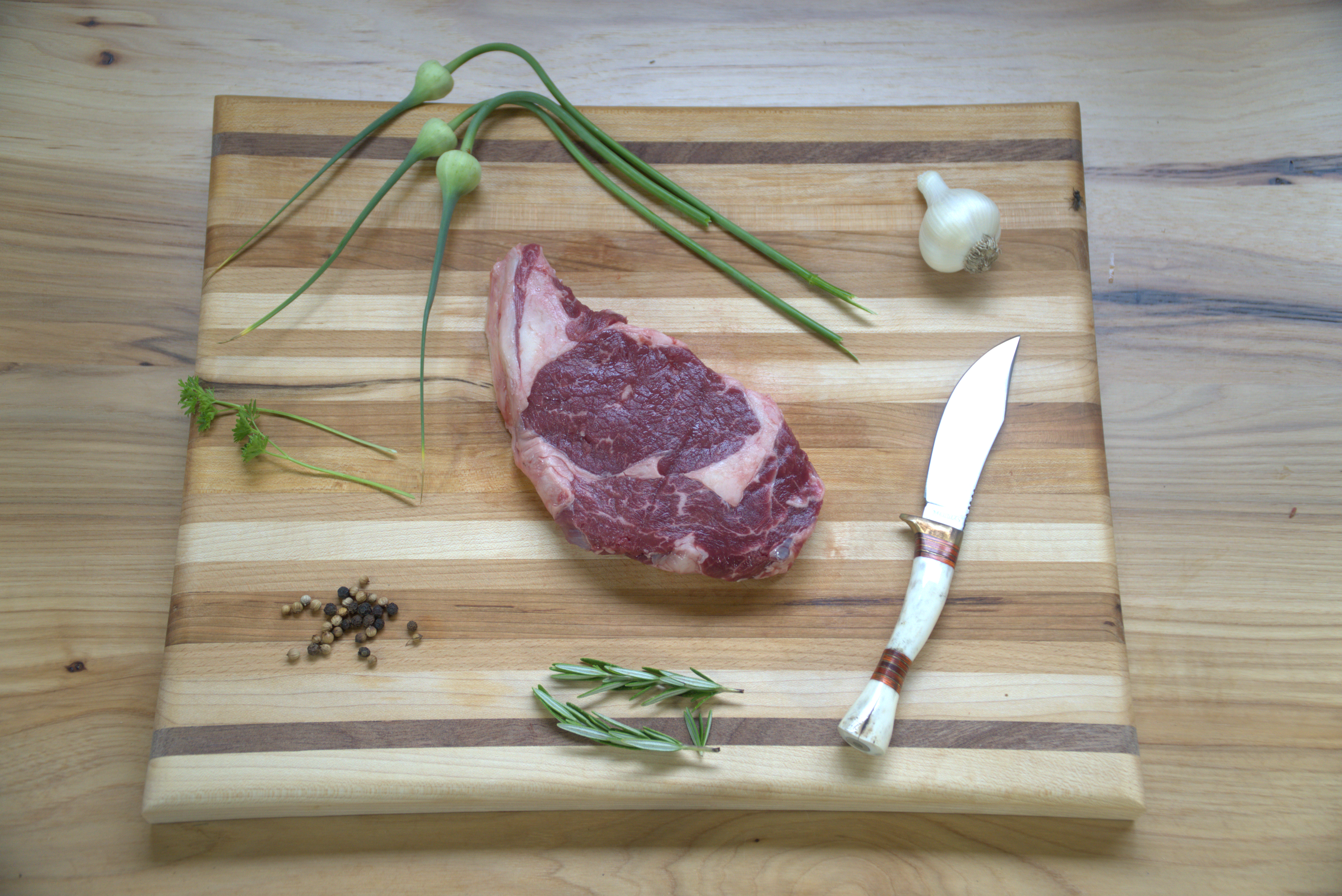 A piece of meat on top of a cutting board.