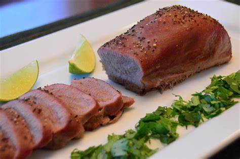 A plate of food with meat and garnish on it.