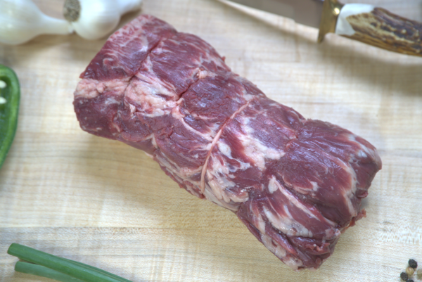 A piece of meat on top of a cutting board.
