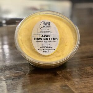 A container of raw butter on top of a table.
