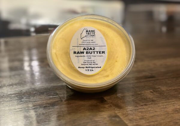 A container of raw butter on top of a table.