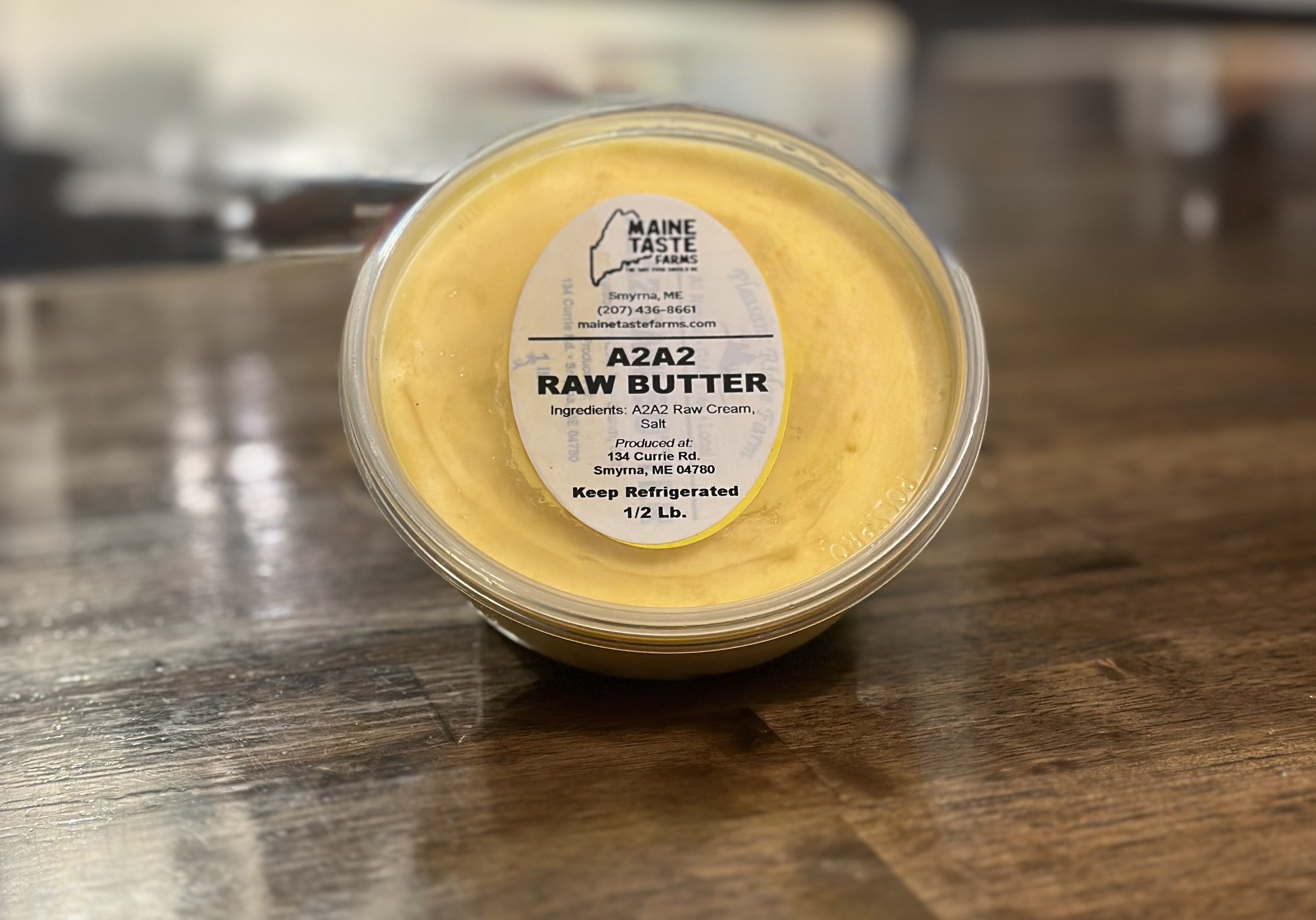 A container of raw butter on top of a table.