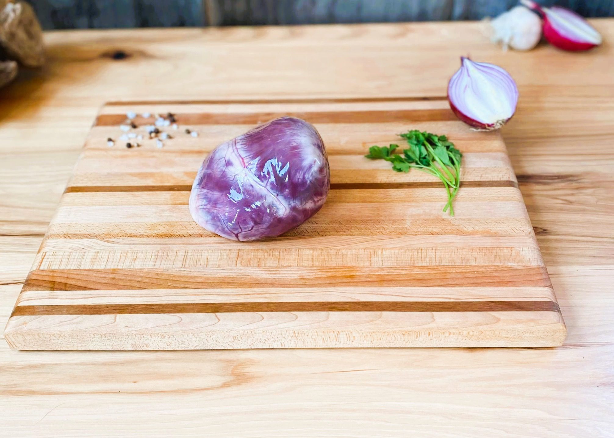 A cutting board with some meat and vegetables on it