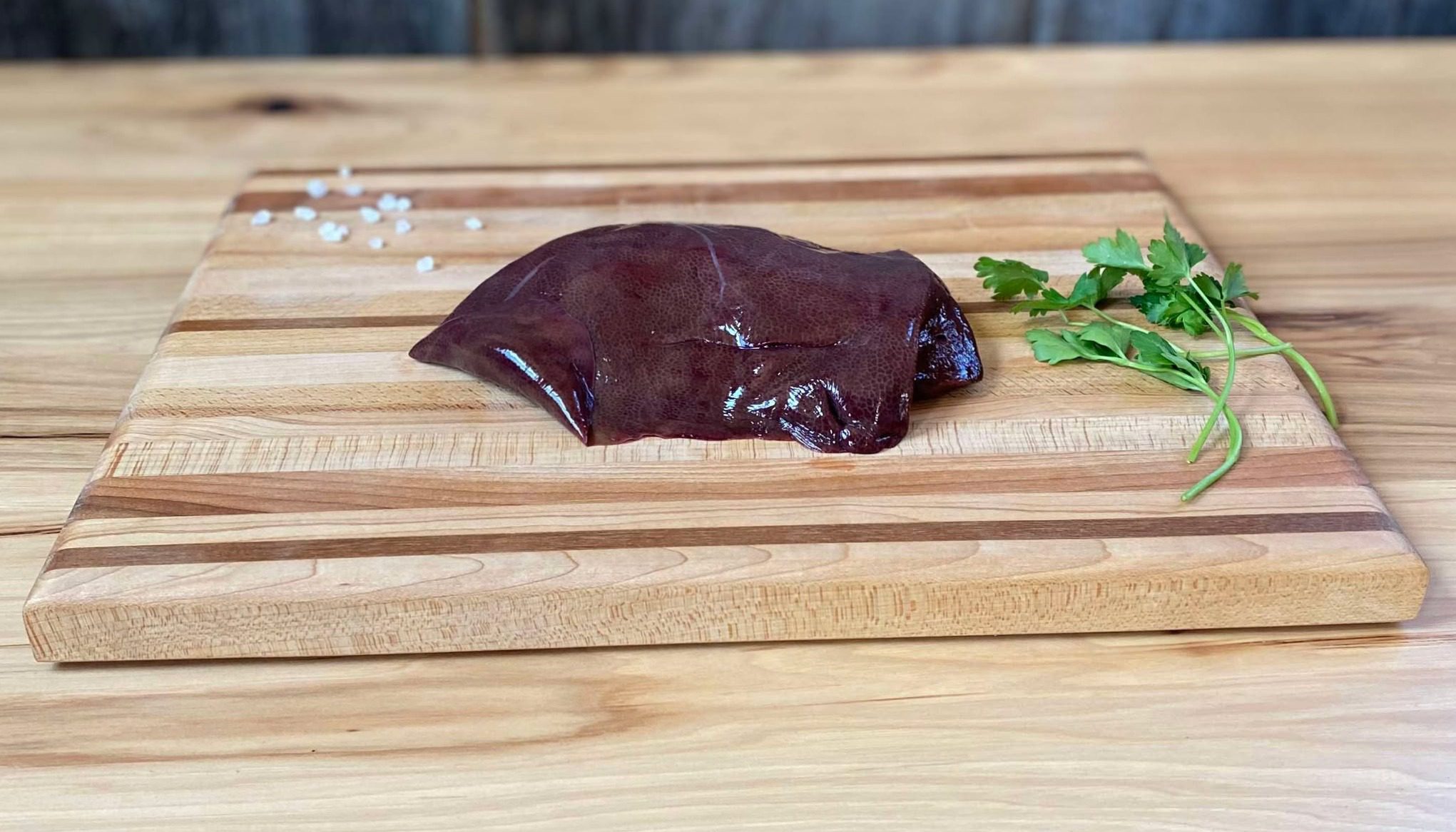 A piece of chocolate sitting on top of a wooden board.
