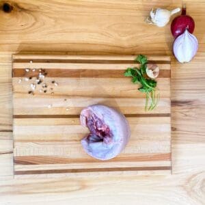 A cutting board with meat and vegetables on it