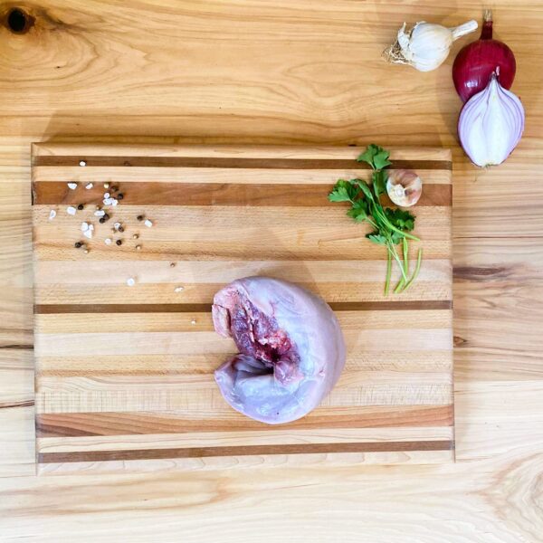 A cutting board with meat and vegetables on it