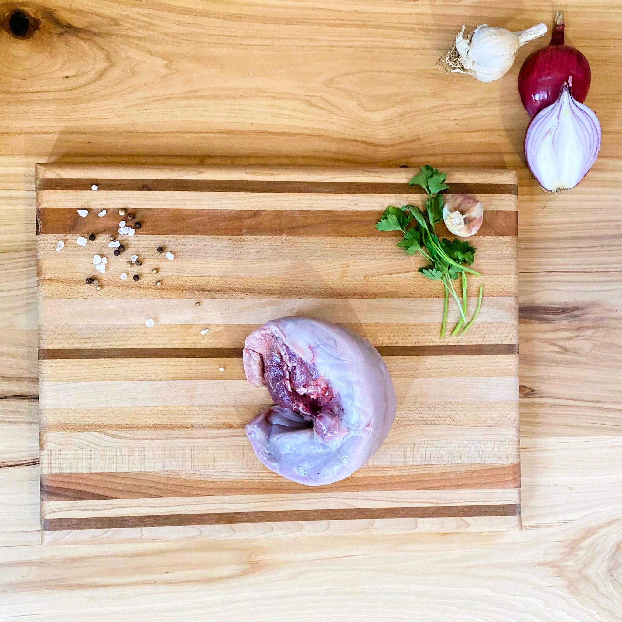 A cutting board with meat and vegetables on it