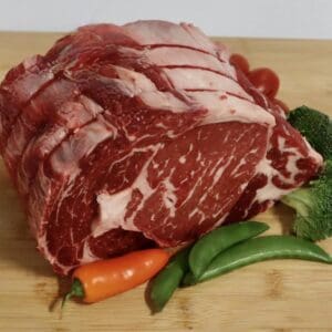 A raw meat and vegetables on a cutting board.