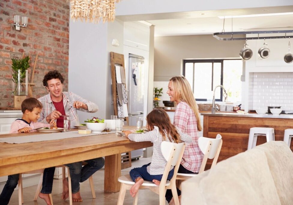 A family sitting at the table in their kitchen.